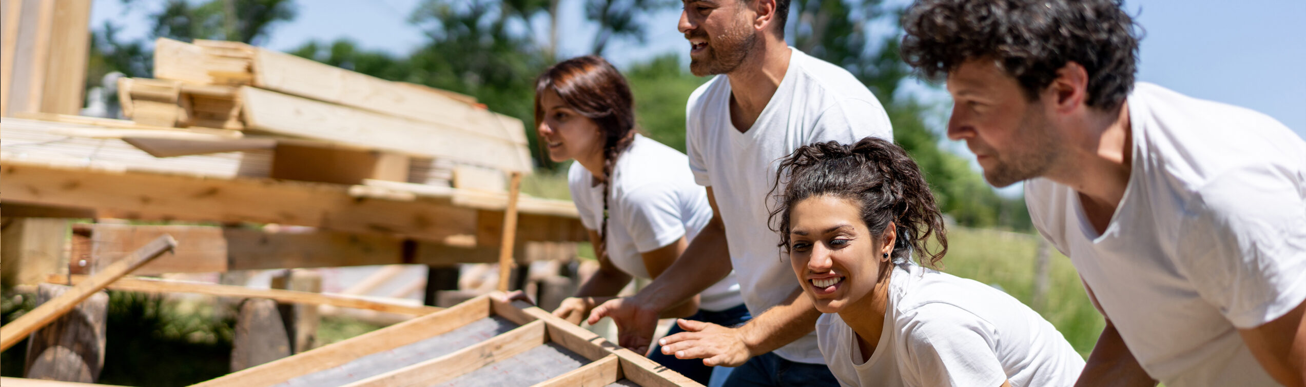 People volunteering to build homes in their community.